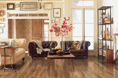 Elegant open concept dark wood floor living room photo in Other with beige walls