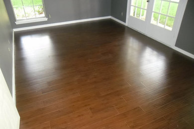 Example of a medium tone wood floor living room design in Houston