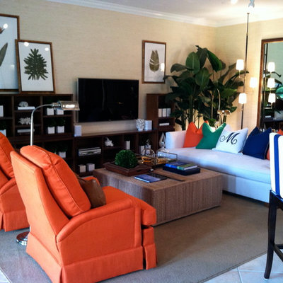 Living room - tropical open concept carpeted living room idea in New York with beige walls and a wall-mounted tv