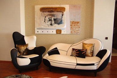 Medium sized contemporary living room in London with beige walls and medium hardwood flooring.