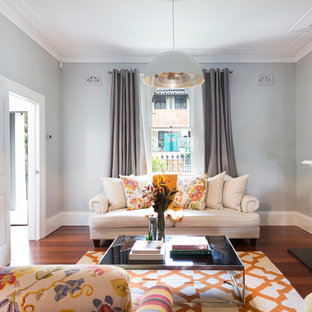 Large traditional formal enclosed living room in Sydney with grey walls, dark hardwood floors, a standard fireplace, a wood fireplace surround, brown floor and no tv.
