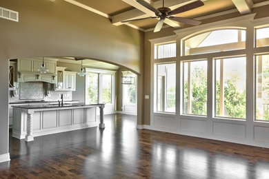 Large trendy open concept dark wood floor and brown floor living room photo in Kansas City with beige walls