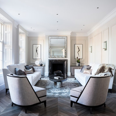 Mid-sized trendy enclosed and formal dark wood floor living room photo in London with a stone fireplace, beige walls, a standard fireplace and no tv