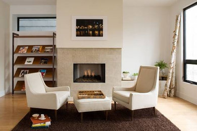 This is an example of a medium sized contemporary formal open plan living room in Chicago with light hardwood flooring, a standard fireplace, no tv, white walls and a tiled fireplace surround.