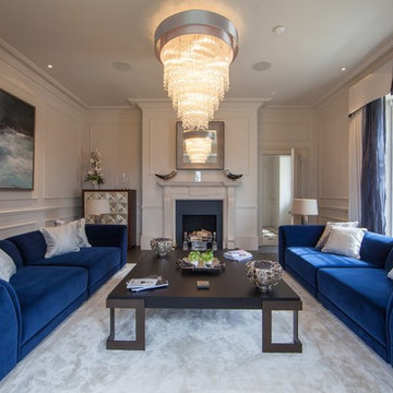 Formal sitting room with blue sofas and pale walls
