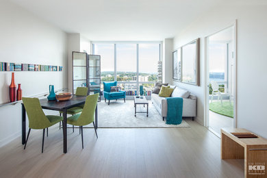 Living room - mid-sized 1950s open concept light wood floor living room idea in New York with white walls