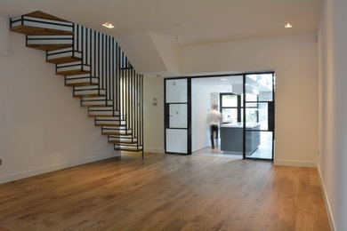 Inspiration for a contemporary light wood floor living room remodel in London with white walls