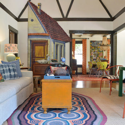 Eclectic formal and enclosed medium tone wood floor living room photo in Dallas with white walls and no tv