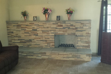 Mid-sized elegant open concept ceramic tile living room photo in Albuquerque with beige walls and a stone fireplace
