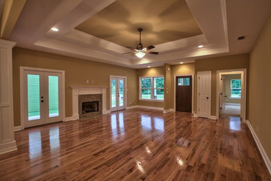 Inspiration for a large timeless open concept dark wood floor living room remodel in Atlanta with beige walls, a standard fireplace, a tile fireplace and no tv