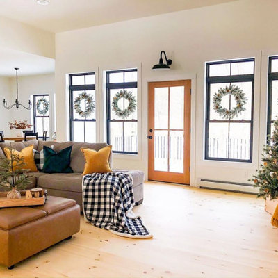 Large cottage open concept painted wood floor living room photo in Tampa with white walls, no fireplace and a media wall