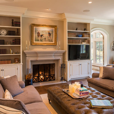Example of a large classic formal and enclosed medium tone wood floor living room design in Philadelphia with beige walls, a standard fireplace, a stone fireplace and a media wall