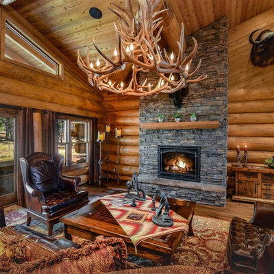 Living room - mid-sized rustic formal and open concept medium tone wood floor and brown floor living room idea in Phoenix with brown walls and a standard fireplace