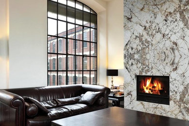 Inspiration for an industrial living room remodel in Boise with white walls, a standard fireplace and a stone fireplace
