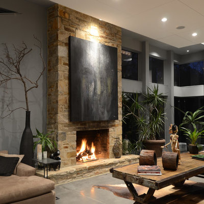 Example of a large trendy open concept concrete floor and gray floor living room design in Baltimore with gray walls, a standard fireplace, a stone fireplace and no tv
