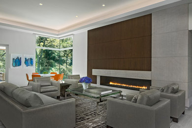 Diseño de salón para visitas abierto contemporáneo de tamaño medio con paredes blancas, suelo de mármol, marco de chimenea de madera, televisor retractable y suelo gris