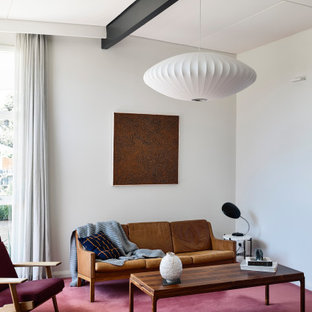 Inspiration for a midcentury living room in Melbourne with white walls, carpet, red floor, exposed beam and vaulted.