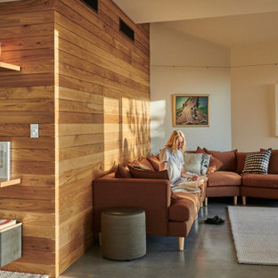 Inspiration for a small contemporary open concept living room in Perth with concrete floors, grey floor, beige walls and wood walls.