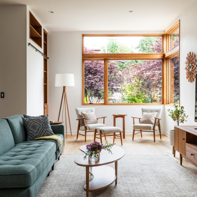 Living room - mid-sized contemporary open concept light wood floor and beige floor living room idea in Seattle with white walls and a tv stand