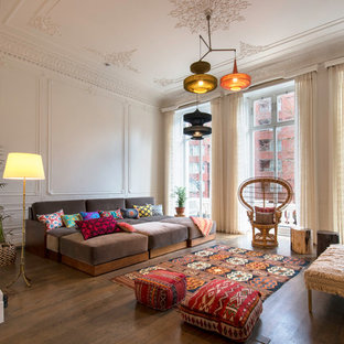 Design ideas for a large eclectic formal open plan living room in London with white walls, brown floors and dark hardwood flooring.