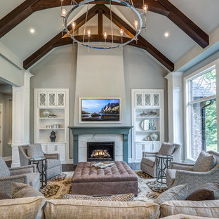 Large transitional formal and open concept dark wood floor and brown floor living room photo in Cincinnati with gray walls, a standard fireplace, a stone fireplace and a concealed tv