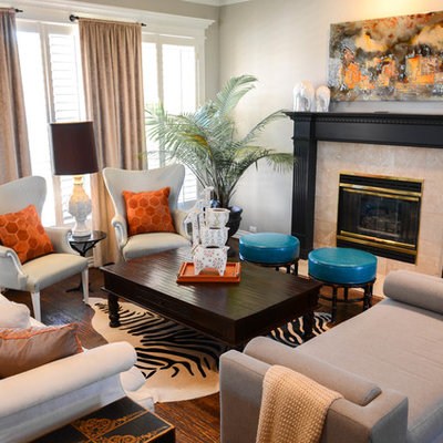 Living room - small eclectic formal and open concept medium tone wood floor living room idea in Dallas with gray walls, a standard fireplace, no tv and a tile fireplace