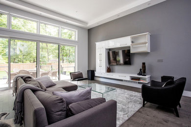 Inspiration for a mid-sized modern open concept living room remodel in Toronto with gray walls and a wall-mounted tv