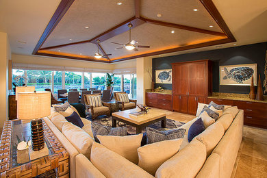 Example of a living room design in Hawaii with blue walls and no fireplace