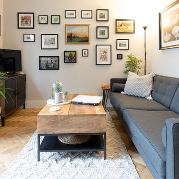 Gallery wall and potted plants make this compact living room a welcoming space