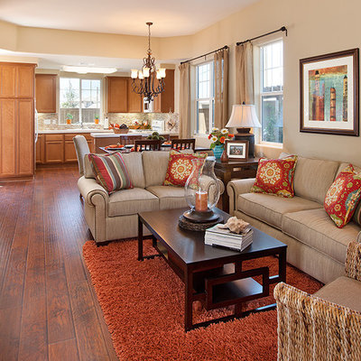 Small trendy enclosed dark wood floor living room photo in Santa Barbara with beige walls, a standard fireplace, a plaster fireplace and a wall-mounted tv