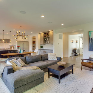 Example of a large arts and crafts open concept medium tone wood floor living room design in DC Metro with white walls, a standard fireplace, a wall-mounted tv and a tile fireplace