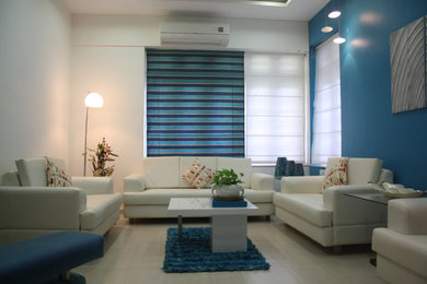 Medium sized modern living room in Ahmedabad with white walls, ceramic flooring, no fireplace and no tv.