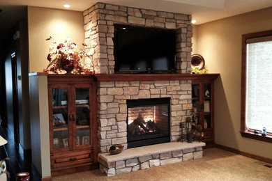 Example of a transitional carpeted living room design in Minneapolis with beige walls, a standard fireplace, a stone fireplace and a wall-mounted tv