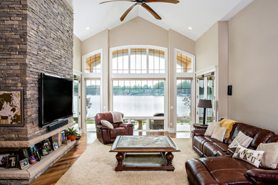 Example of a mid-sized beach style open concept light wood floor living room design in Detroit with beige walls and no fireplace