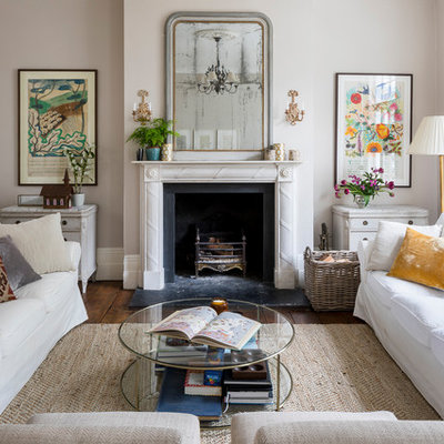 Living room - traditional formal medium tone wood floor and brown floor living room idea in London with gray walls, a stone fireplace, a standard fireplace and no tv