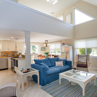 Mid-sized beach style open concept light wood floor and white floor living room photo in Other with a corner fireplace, a stone fireplace, a media wall and beige walls