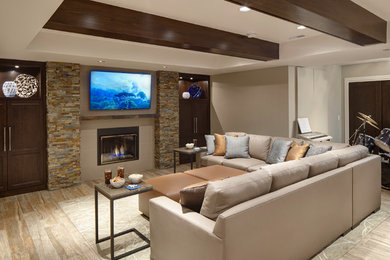 Example of a transitional open concept ceramic tile living room design in Chicago with a wall-mounted tv, beige walls, a standard fireplace and a tile fireplace