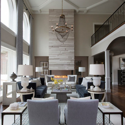 Inspiration for a large transitional formal and open concept medium tone wood floor living room remodel in Other with gray walls, a two-sided fireplace, a stone fireplace and no tv