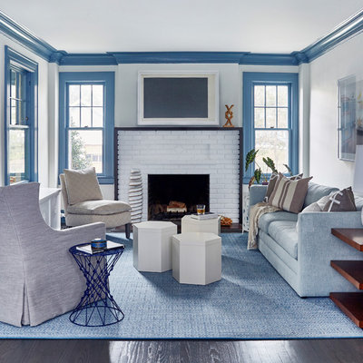 Inspiration for a large coastal formal and enclosed dark wood floor and brown floor living room remodel in New York with white walls, a standard fireplace, a brick fireplace and no tv