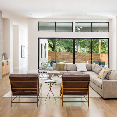 Large trendy open concept light wood floor and beige floor living room photo in Dallas with white walls, a ribbon fireplace, a tile fireplace and a wall-mounted tv