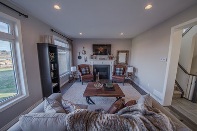 Example of a transitional open concept living room design in Toronto with gray walls, a standard fireplace, a tile fireplace and a wall-mounted tv