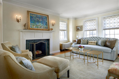 This is an example of a medium sized classic living room in Chicago with yellow walls, a standard fireplace and a stone fireplace surround.