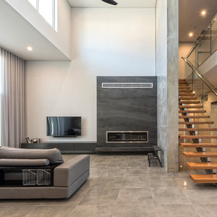 Contemporary formal open concept living room in Sydney with white walls, concrete floors, a ribbon fireplace, a wall-mounted tv and grey floor.