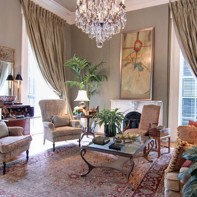 Mid-sized elegant formal and open concept dark wood floor living room photo in New Orleans with gray walls, a standard fireplace, a plaster fireplace and no tv