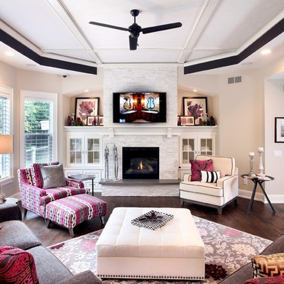 Mid-sized transitional open concept and formal medium tone wood floor living room photo in Grand Rapids with beige walls, a standard fireplace, a wall-mounted tv and a stone fireplace