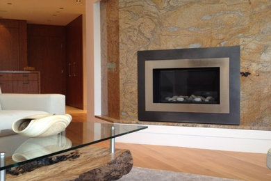 Example of a mid-sized trendy open concept medium tone wood floor living room design in Vancouver with white walls, a corner fireplace and a stone fireplace