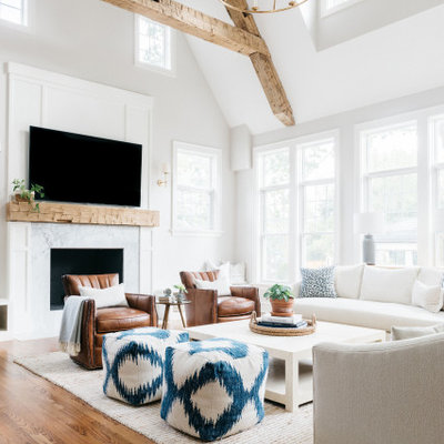 Living room - transitional medium tone wood floor and brown floor living room idea in Chicago with gray walls, a standard fireplace, a stone fireplace and a wall-mounted tv