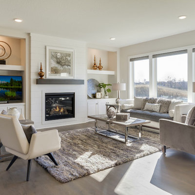 Transitional open concept dark wood floor and brown floor living room photo in Minneapolis with beige walls, a standard fireplace, a tv stand and a wood fireplace surround