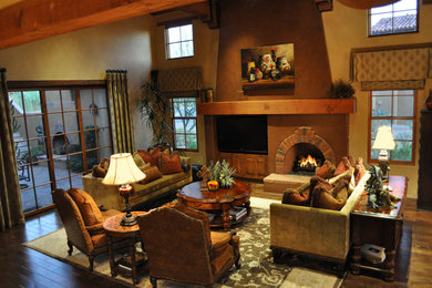 Living room - large contemporary dark wood floor and brown floor living room idea in Phoenix with brown walls, a standard fireplace, a brick fireplace and a media wall