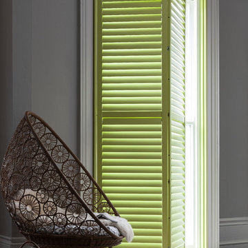 Green Tracked Window Shutters in Taupe Living Room